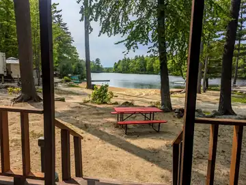 View from the porch of The Cottage looking out over the sandy beach and Swains Lake